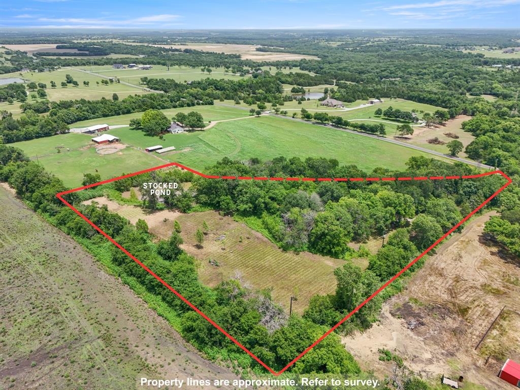 3165 Bennett Road Howe, TX 75459 - Photo 3 of 6 Elevated aerial view of the property with approximate boundaries, mature trees, open areas, and stocked pond.