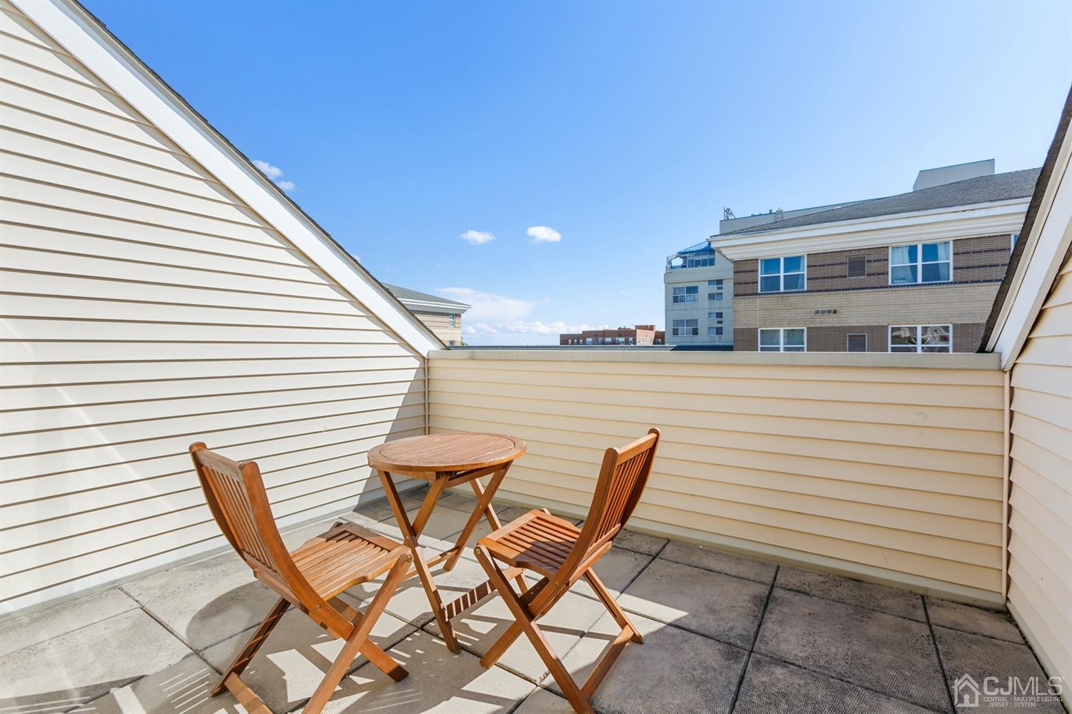 368 Rector Street, Unit 517 Perth Amboy, NJ 08861 - Photo 22 of 27 a patio with a table and chairs and potted plants