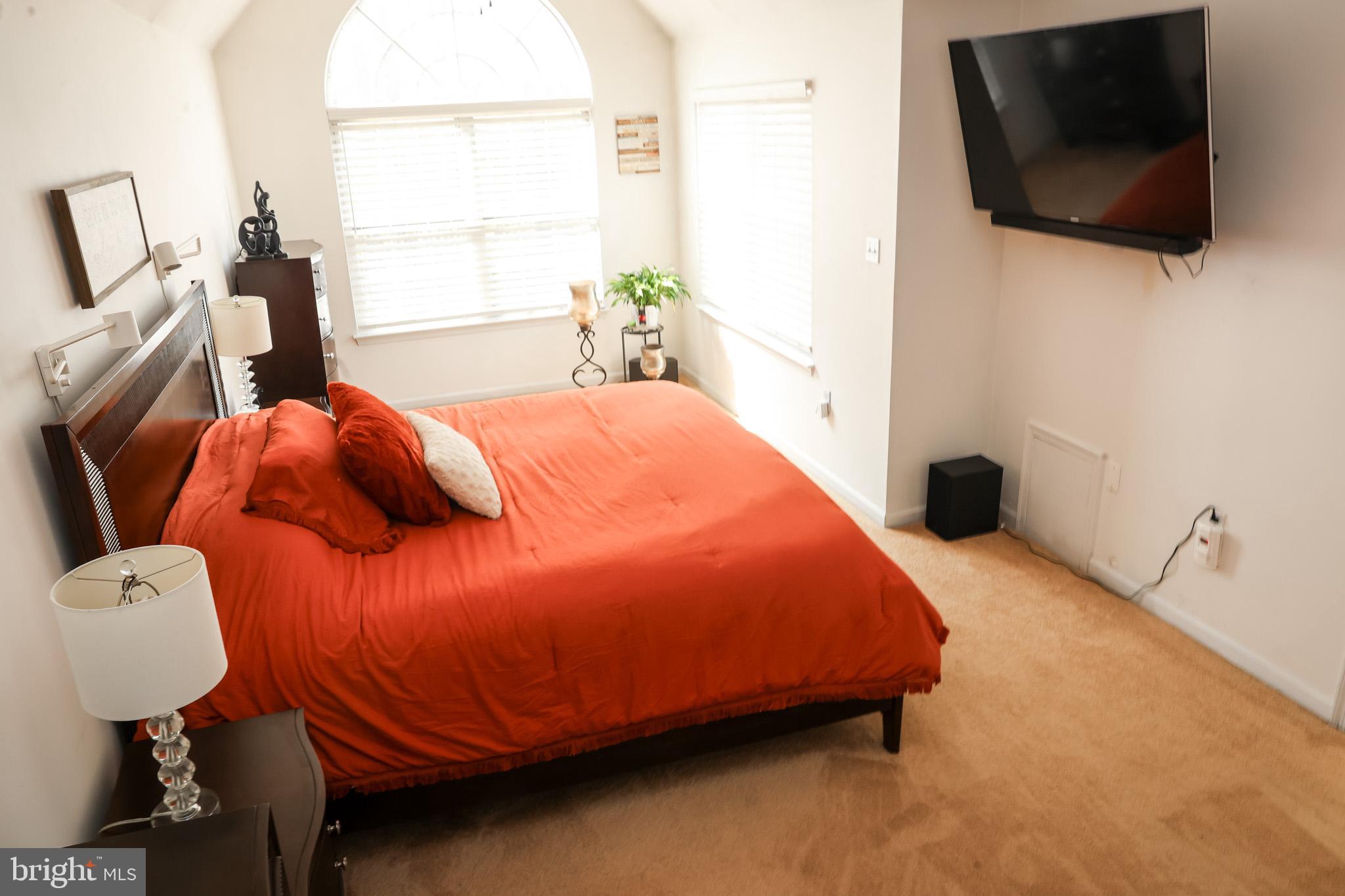 4234 Huntshire Road Randallstown, MD 21133 - Photo 25 of 43 a bedroom with a bed and flat screen tv
