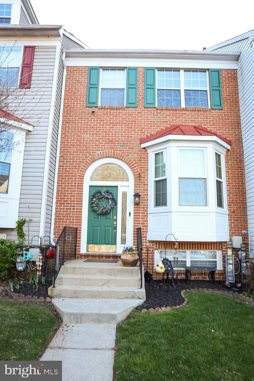 4234 Huntshire Road Randallstown, MD 21133 - Photo 4 of 43 a front view of a house with a garden