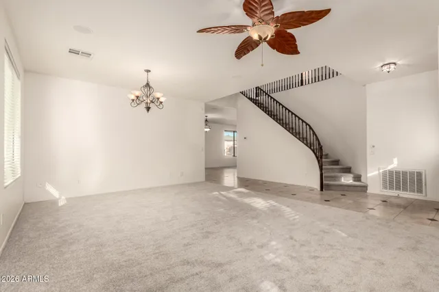 a view of empty room with ceiling fan