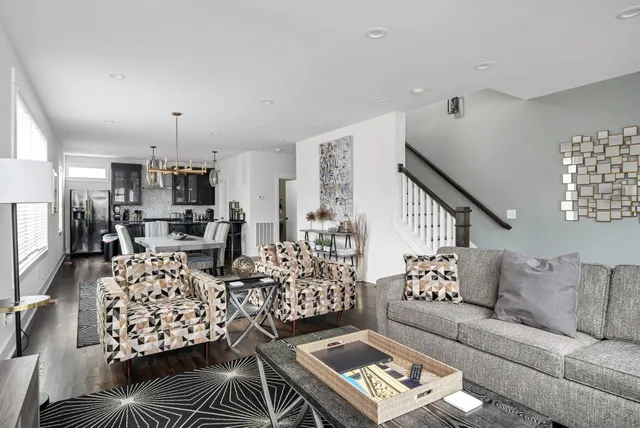 a living room with furniture and a chandelier