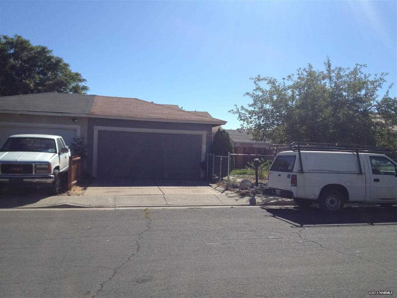 6550 Flower Street Reno, NV 89506 - Photo 1 of 1 a couple of cars parked in front of a house