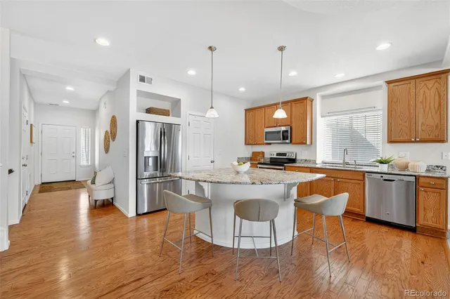 a kitchen with granite countertop sink and cabinets