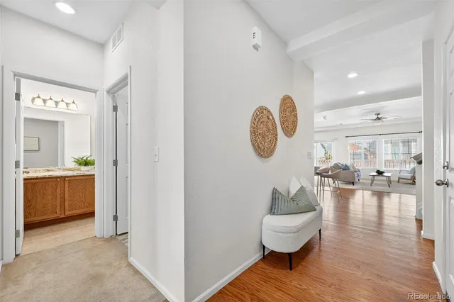 a bathroom with a granite countertop sink a toilet and shower