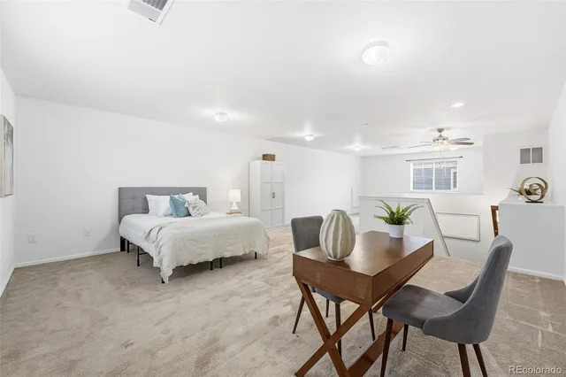 a bedroom with a bed and a desk