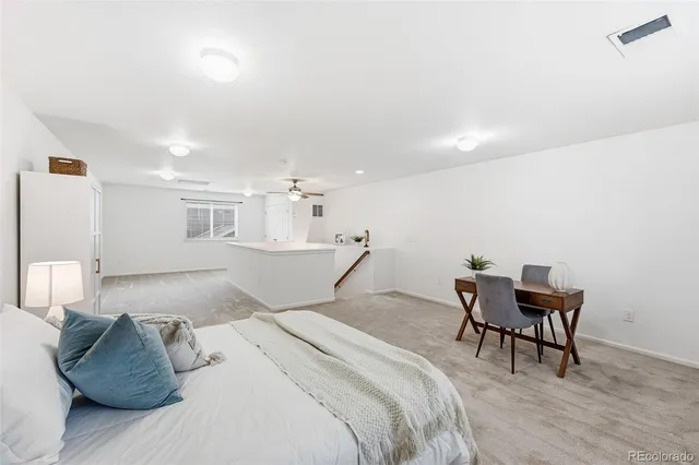 a view of a livingroom with furniture and staircase