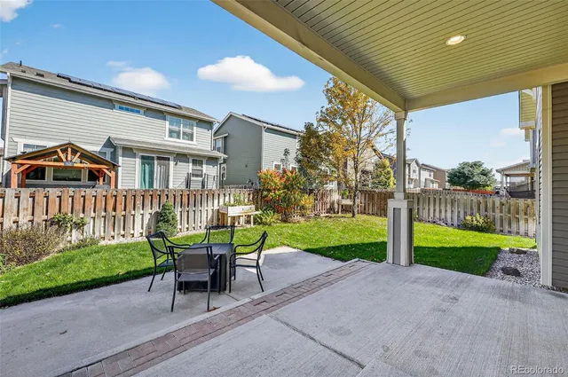 a house view with outdoor seating space and garden