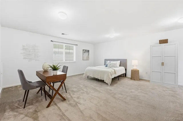 a spacious bedroom with a bed and a window