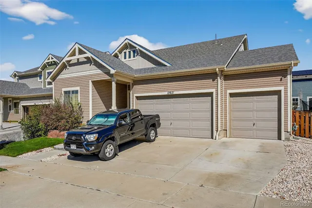 a car parked in front of white house