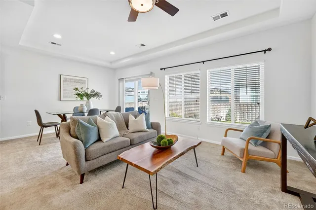 a kitchen with stainless steel appliances granite countertop a refrigerator a stove top oven a sink dishwasher a dining table and chairs with wooden floor