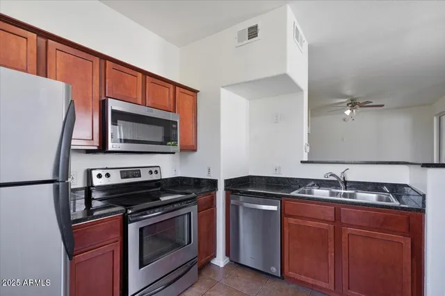 a kitchen with a refrigerator stove and sink