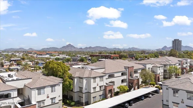 an aerial view of a house with garden space and street view