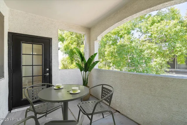 a view of a balcony dining table and chairs