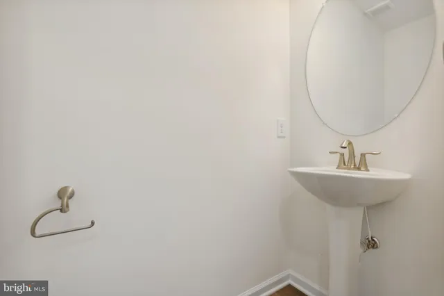 a bathroom with a sink and mirror