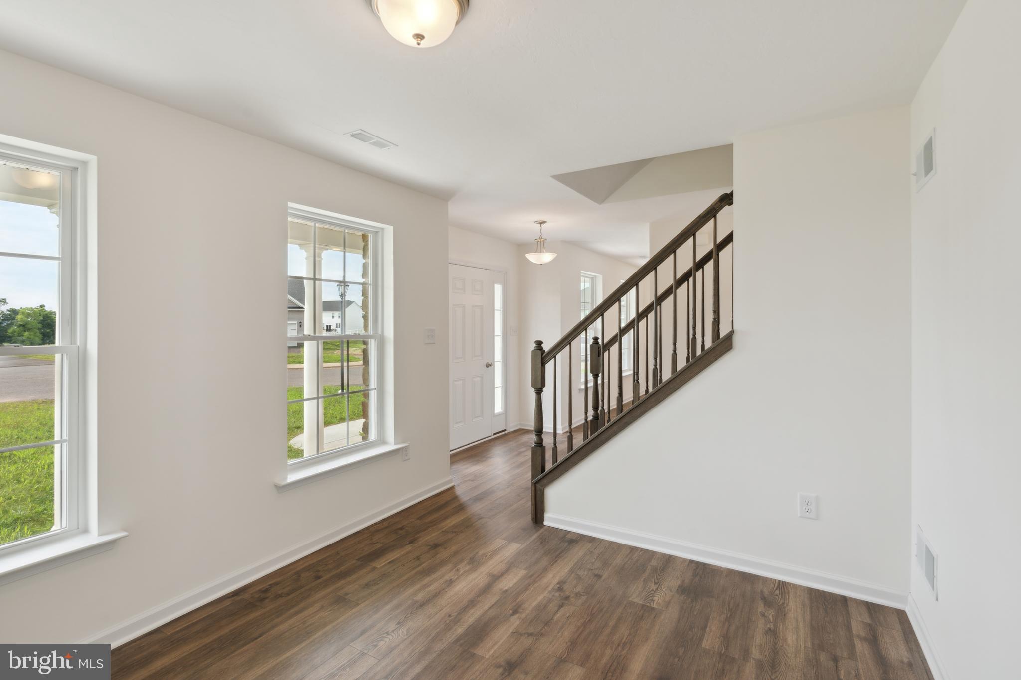 62 Flint Drive Hanover, PA 17331 - Photo 3 of 18 a view of an entryway with wooden floor and windows