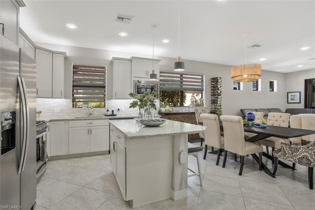 7682 Jacaranda Lane Naples, FL 34114 - Photo 11 of 44 a kitchen with appliances cabinets and furniture