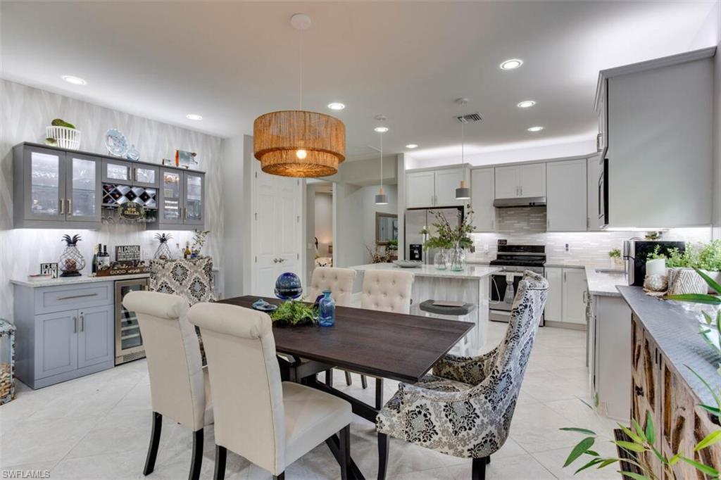 7682 Jacaranda Lane Naples, FL 34114 - Photo 12 of 44 a view of a dining room with furniture and wooden floor
