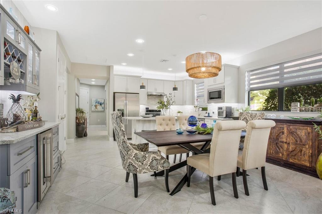 7682 Jacaranda Lane Naples, FL 34114 - Photo 14 of 44 a dining room with furniture and window