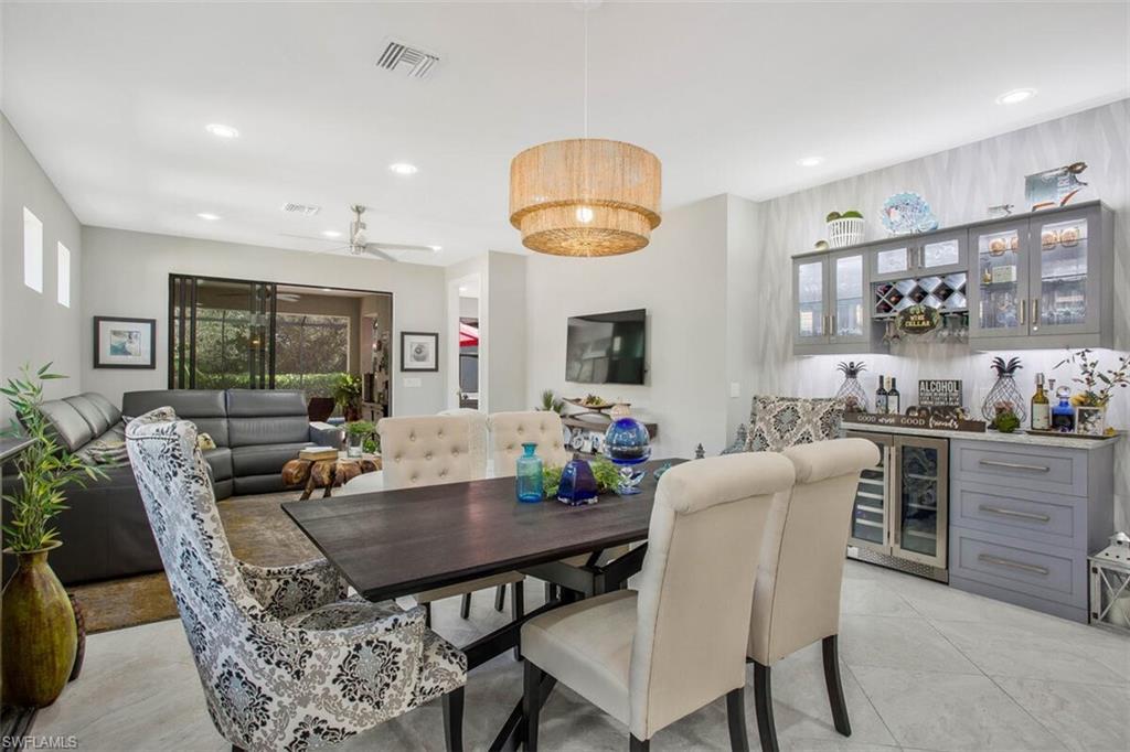 7682 Jacaranda Lane Naples, FL 34114 - Photo 15 of 44 a view of a dining room with furniture