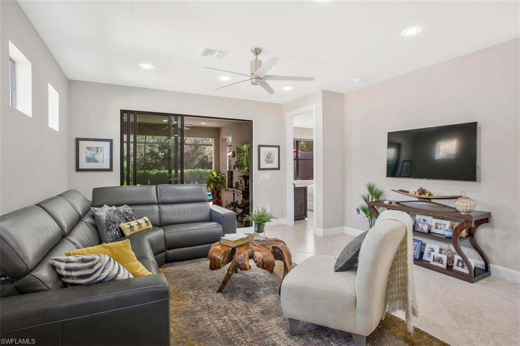 7682 Jacaranda Lane Naples, FL 34114 - Photo 16 of 44 a living room with furniture and a flat screen tv
