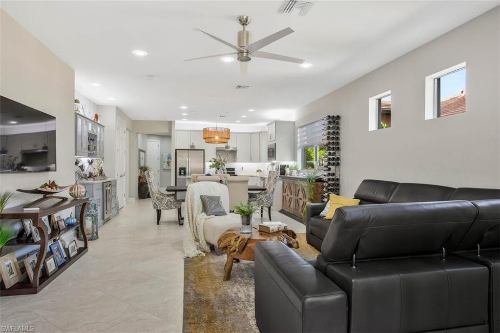 7682 Jacaranda Lane Naples, FL 34114 - Photo 17 of 44 a living room with furniture and a flat screen tv