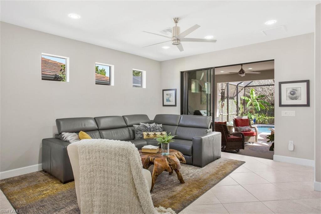 7682 Jacaranda Lane Naples, FL 34114 - Photo 18 of 44 a living room with furniture and a large window
