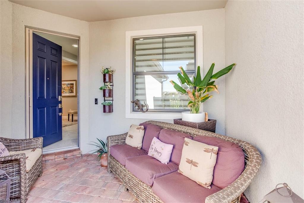 7682 Jacaranda Lane Naples, FL 34114 - Photo 2 of 44 a living room with furniture and a potted plant