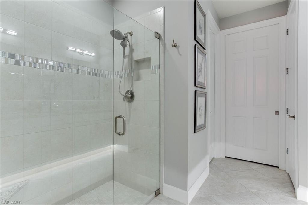 7682 Jacaranda Lane Naples, FL 34114 - Photo 22 of 44 a bathroom with a glass shower door
