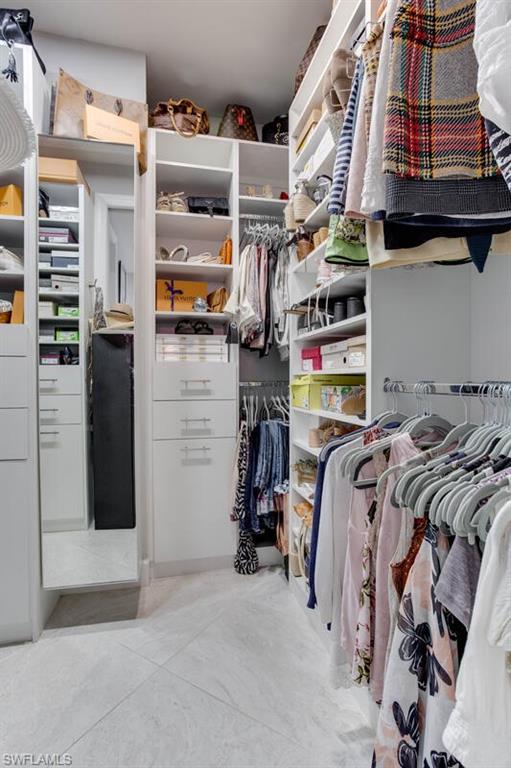 7682 Jacaranda Lane Naples, FL 34114 - Photo 25 of 44 a view of walk in closet with clothes and shoes