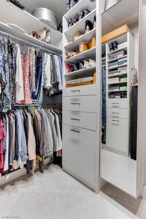 7682 Jacaranda Lane Naples, FL 34114 - Photo 26 of 44 a view of walk in closet with clothes and shoes