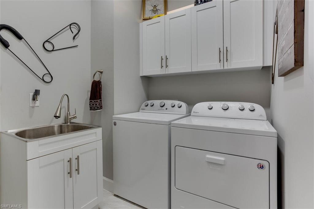 7682 Jacaranda Lane Naples, FL 34114 - Photo 27 of 44 a utility room with dryer and washer