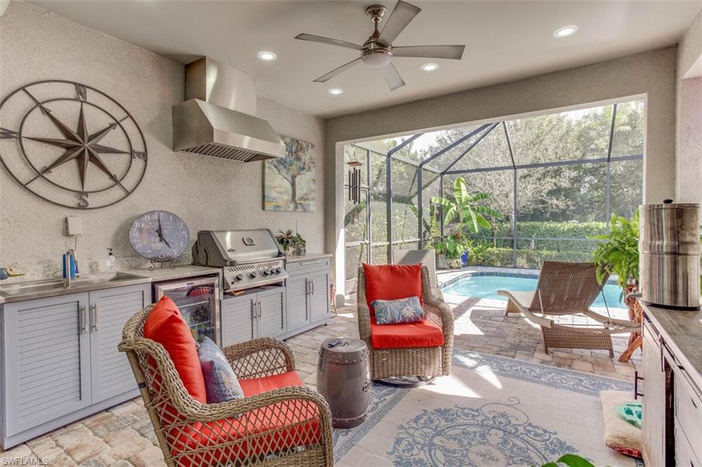 7682 Jacaranda Lane Naples, FL 34114 - Photo 28 of 44 a outdoor kitchen with stainless steel appliances granite countertop a stove a sink and a large window
