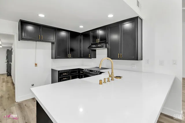 a kitchen with a refrigerator and a sink