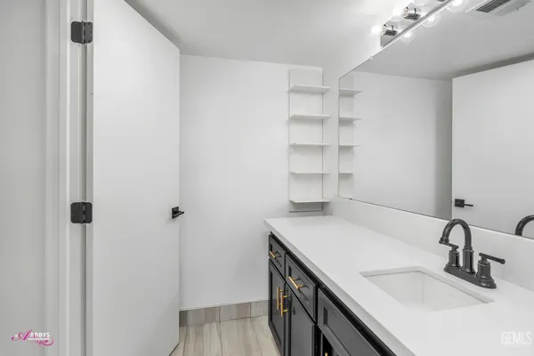 a view of a room with a ceiling fan and a window