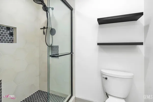 a view of room with window ceiling fan and wooden floor