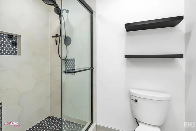 a view of a room with a ceiling fan and a window