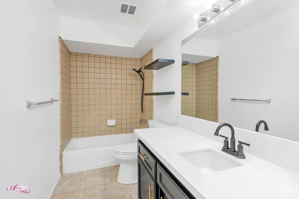 a view of a house with backyard and a tree