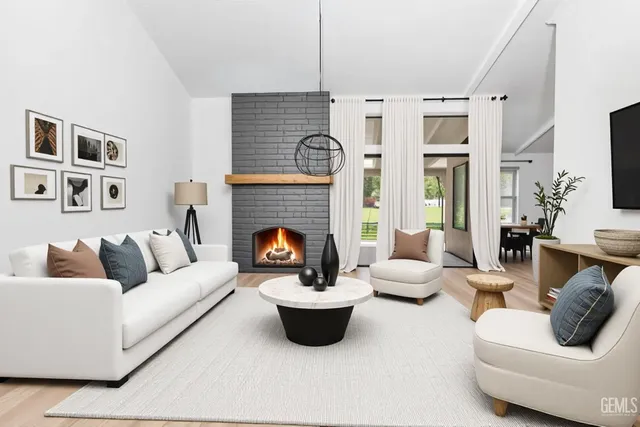 a living room with furniture fireplace and window