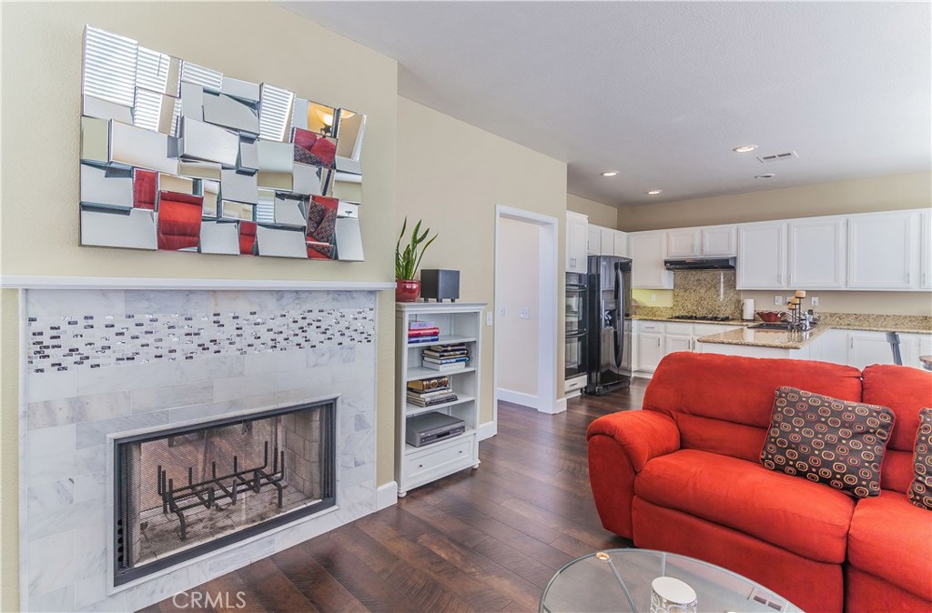 743 Orchard Loop Azusa, CA 91702 - Photo 21 of 39 a living room with furniture and a fireplace
