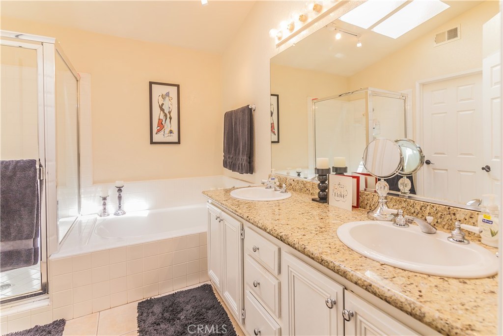 743 Orchard Loop Azusa, CA 91702 - Photo 26 of 39 a bathroom with a granite countertop sink and a mirror
