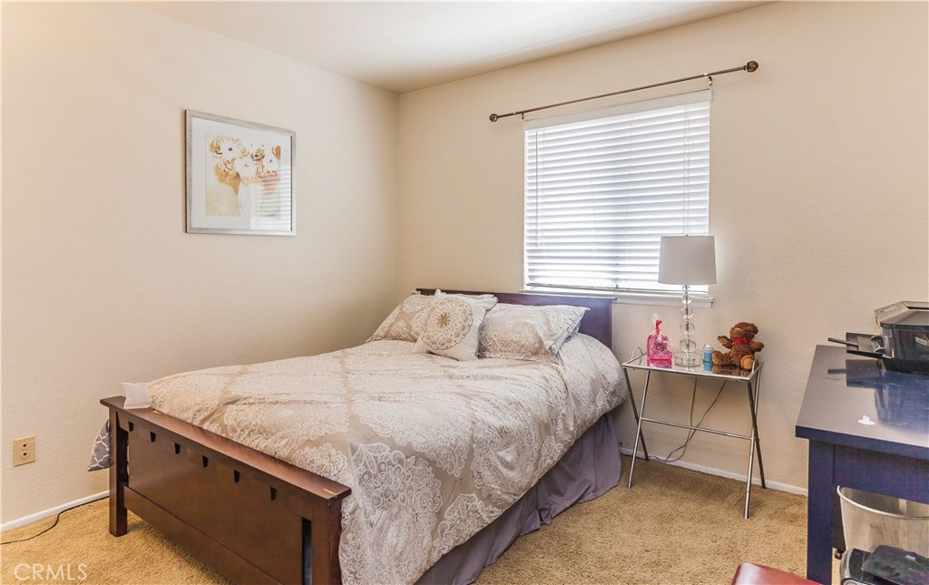 743 Orchard Loop Azusa, CA 91702 - Photo 29 of 39 a bedroom with bed and a window