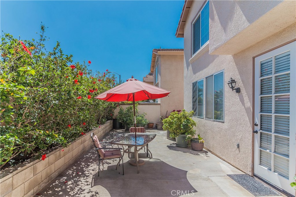 743 Orchard Loop Azusa, CA 91702 - Photo 35 of 39 a view of a patio with a table and chairs under an umbrella