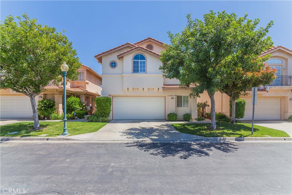 743 Orchard Loop Azusa, CA 91702 - Photo 4 of 39 a front view of a house with a yard and garage