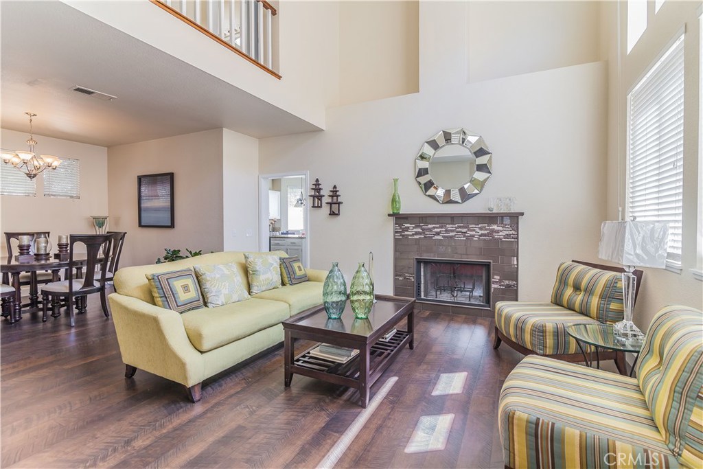 743 Orchard Loop Azusa, CA 91702 - Photo 9 of 39 a living room with furniture a fireplace and a large window