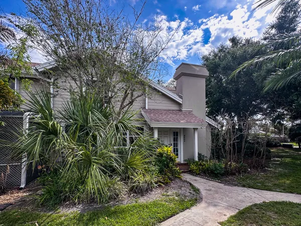 a front view of a house with a garden