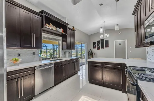 a kitchen with stainless steel appliances granite countertop a stove and a sink