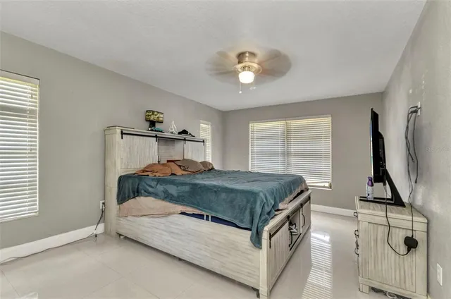 a bedroom with a bed and painting on the wall