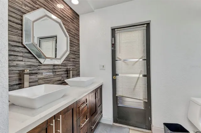 a white toilet sitting next to a bathroom sink