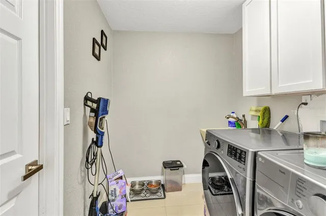 a spacious bedroom with a bed and a chandelier